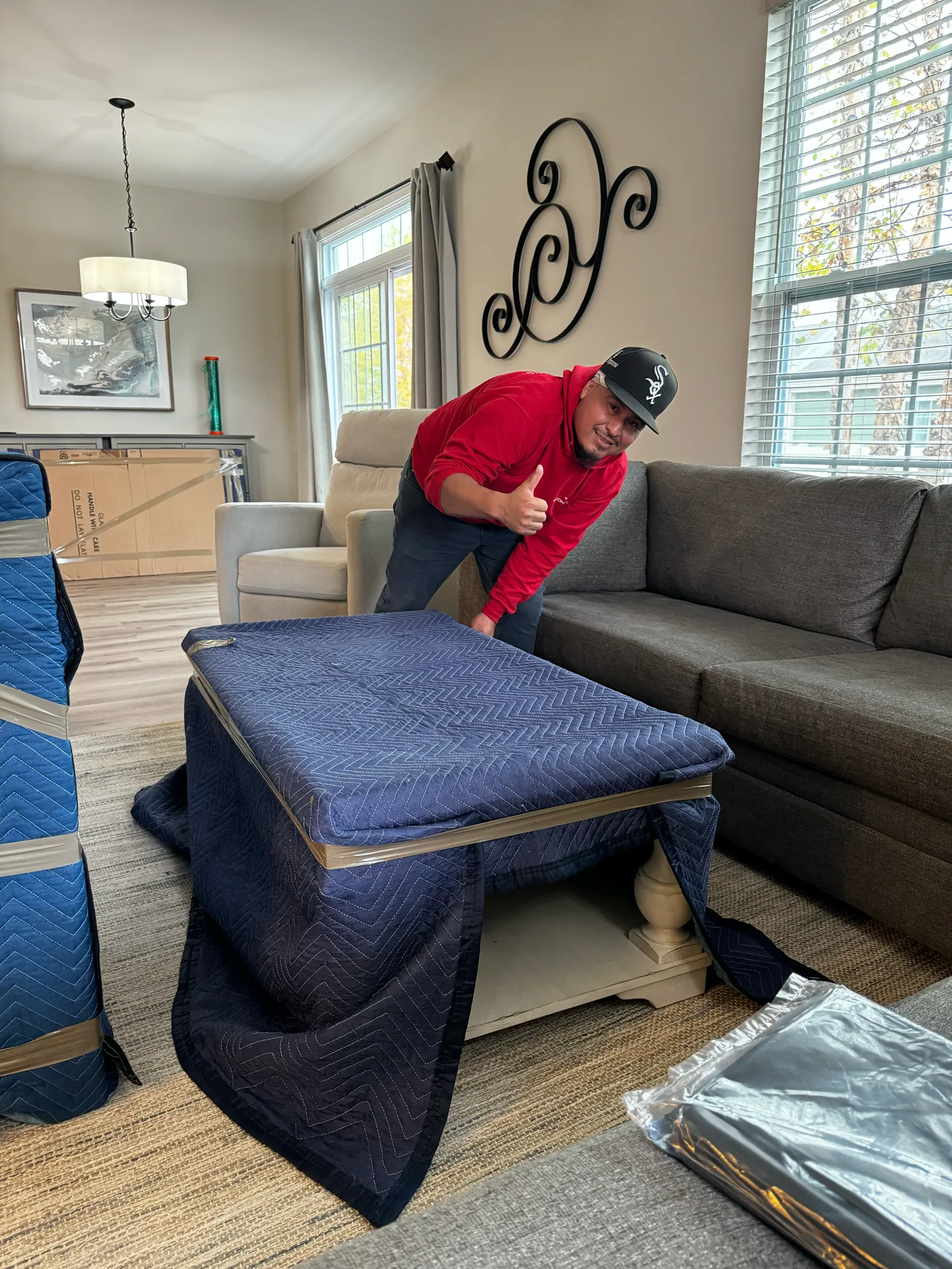 Crew wrapping and protecting furniture before a Bartlett move